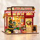 DIY Christmas candy house miniature model with warm lights - front hero view
