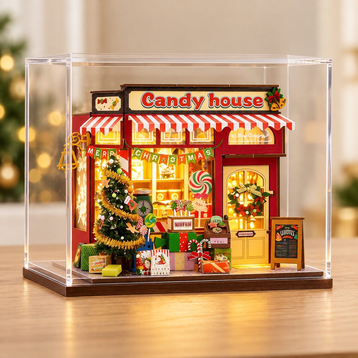 DIY Christmas candy house miniature displayed in a clear protective cover