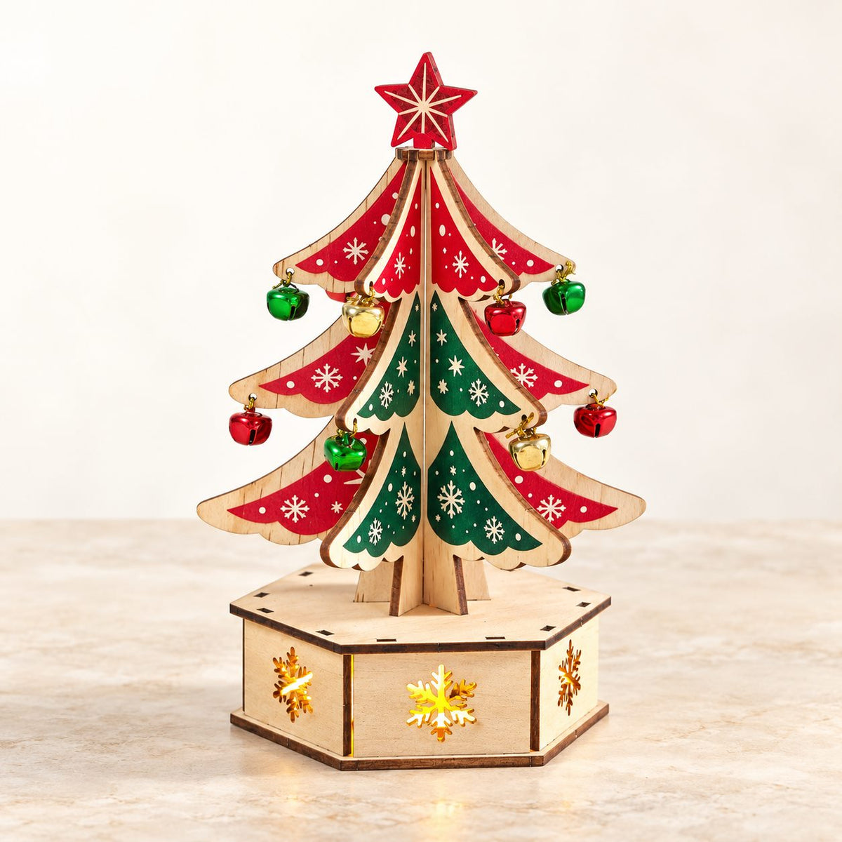 DIY wooden Christmas tree decoration with bells and illuminated snowflake base - hero view